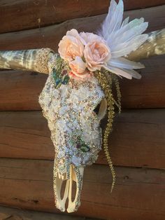 an animal skull with flowers on it's head