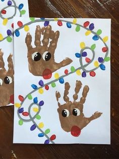 two handprints with christmas lights on them, one is brown and the other is white