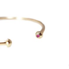 Rubied cuff - each Ruby stone is set delicately in a tapered round 14kt setting. She is adjustable, a heavier cuff then our Sloane, Opal, Garnet & Jade. 14/20 gold filled - 2.4mm wire 14kt Setting 2 - 2mm AA Ruby 6.5" Adjustable 14k Gold Bangle, Fine Jewelry, Adjustable Round Cuff Bracelet Fine Jewelry, Dainty Adjustable 14k Gold Bangle, Dainty Adjustable Yellow Gold Cuff Bracelet, Adjustable Dainty 14k Gold Bangle, Adjustable Yellow Gold Round Cuff Bracelet, Adjustable 14k Gold Cuff Bracelet For Everyday, Adjustable Dainty Bangle For Formal Occasions, Adjustable Tarnish Resistant Bangle