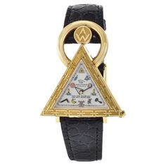 The Waltham 18K Gold Triangular Masonic Wristwatch is a distinctive timepiece with notable features, crafted circa 2000. It houses a nickel-finished lever movement with 17 jewels, ensuring precision and reliability. The silver opaline dial is adorned with Masonic ritual signs, serving as unique hour markers, and features the motto "Love Your Fellow Man Lend Him A Helping Hand." Encased in a triangular-shaped 18K gold case with an engraved bezel, the watch exudes both elegance and symbolism. The Masonic Ritual, Masonic Watches, Helping Hand, Helping Hands, Functional Accessories, Gold Case, Love Your, Time Piece, Wrist Watch