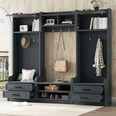 an entryway with black furniture and white rugs on the floor in front of a wooden paneled wall