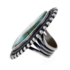 this absolutely stunning Navajo ring is a bold conversation piece handcrafted by the prominent Navajo artist E R B this ring spellbinds with its size as well as its beauty executed in the classic Navajo style the ring features a gorgeous and sizeable center piece of Royston turquoise stone measuring approximately 7/8" x 1 5/8" inlaid in sterling silver bezel this ring is a true showpiece handmade & stamped by E R B bezel and band handmade from .925 Sterling Silver size 9 approximate centerpi Untreated Southwestern Style Ring Jewelry, Handmade Southwestern Opal Ring, Bohemian Chrysocolla Ring Jewelry, Bohemian Chrysocolla Ring, Southwestern Sterling Silver Rings With Large Stone, Southwestern Sterling Silver Ring With Large Stone, Bohemian Oval Chrysocolla Ring, Southwestern Style Turquoise Ring With Patina, Artisan Turquoise Ring With Inlay