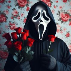 a person in a black hoodie holding roses with a scream mask on their face