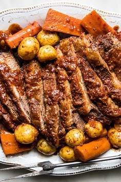 meat, potatoes and carrots on a platter