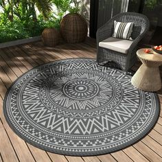 an outdoor area rug with a chair and table