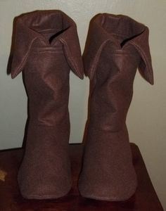 two brown vases sitting on top of a wooden table