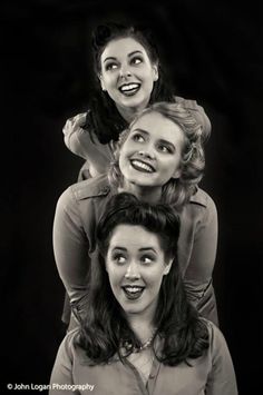 three women are posing for the camera with their heads turned to look like they're laughing