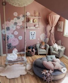 a child's bedroom decorated in pink and gray with flowers on the wall, teddy bears sitting on swings