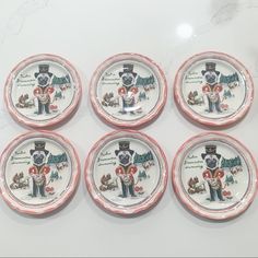 six decorative plates with an image of a man and dog on them, all decorated in pink