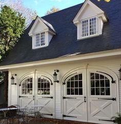 a white house with three windows and two doors