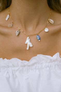 Our Mana necklace is your summertime vacay staple. Drift away to palm lined beaches, collecting shells, balmy summer nights & midnight swims. Paired beautifully with fresh sun-kissed skin & your favorite all white outfit. - 18k gold filled chain - Hand selected luminous freshwater baroque pearls - Lapis Lazuli - Quartz crystal - Mixed shells - Gold filled wire - Approx 16 inches end to end Gold filled jewelry is easily 100 times thicker compared to common gold plating & lasts just li Gold Jewelry For Summer Beach Weddings, Gold Jewelry For Beach Wedding In Summer, Dainty Beach Jewelry With Delicate Chain, Ocean-inspired Necklaces For Summer Gifts, Elegant Shell Necklace For Summer Vacation, Ocean-inspired Necklaces As Summer Gifts, Elegant Summer Shell Necklace For Vacation, Summer Ocean-inspired Necklaces, Dainty Necklace With Delicate Chain For Beach