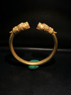 A Beautiful Old Bracelet Of Gold At The Two Ends Decorated With Tiger Head Figure Symbolize Might Strength. Worn For Protection and prosperity Good patina on the surface and certification of gold available On Request Of Customer Great quality and excellent collection Bronze Bracelet For Ceremonial Occasions, Brass Temple Jewelry Bracelet, Gold Collectible Bracelet, Luxury Carved Gold Jewelry, Unique Yellow Gold Brass Bracelet, Unique Yellow Gold Bracelets For Ceremonial Occasions, Unique Gold Cuff Bracelet With Intricate Design, Unique Gold Jewelry For Rituals, Festival Yellow Gold Brass Bracelet