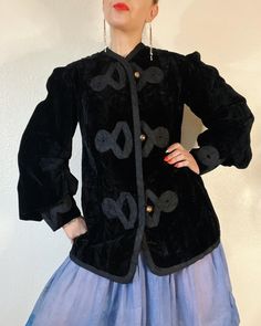 "Victorian Velvet. Phenomenal Antique Edwardian/Victorian black velvet jacket with stunning cloisonné buttons, braided rope details, blouson sleeves with extra wide cuffs, and the most incredible ivory silk lining with embroidered boarder. She's full of details & absolutely incredibly wearable. I'm in awe.  Fits L (I'm about a M), but please use measurements as fit guide. 16.25\" shoulder  20\" bust (on the half)  19.5\" waist (on the half)  22.25\" hip (on the half)  23.25\" sleeve 30\" length  Fully lined in silk - ivory  Velvet  Center front loop metal cloisonné button closures  Princess seams front and back  Gathered shoulder caps  3 piece big blouson sleeves with pleating details and wide cuff with gathering  Braided trim throughout exterior front, back and sleeve cuffs  Interior embr Black Velvet Jacket, Gothic Victorian, Sweater Fits, Braided Rope, Ivory Silk, Velvet Jacket, Shearling Coat, Wide Cuff, Princess Seam