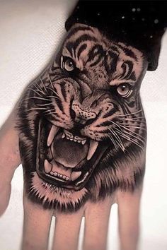 a hand with a tiger tattoo on it