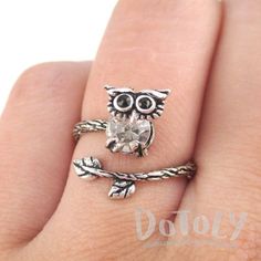 This adjustable ring is made with a band in the shape of a branch wrapped around your finger with a little baby owl on the end with rhinestone details! So cute and pretty! Size: Adjustable!Material: Tin Alloy, Rhinestones Store FAQ | Shipping Info | Returns & Exchanges Cute Adjustable Open Ring Jewelry, Whimsical Adjustable Rings, Cute Adjustable Nickel-free Rings, Adjustable Nickel-free Cute Rings, Adjustable Cute Nickel-free Rings, Owl On A Branch, Animal Ring, Baby Owl, Animal Rings