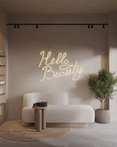 a white couch sitting next to a table in a living room under a neon sign