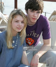 two young people sitting next to each other