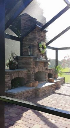 an outdoor fireplace in the middle of a patio