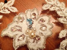 a close up view of an elaborate brooch with pearls