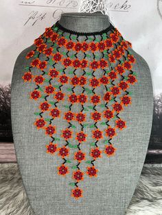 Beautiful necklace of flowers of chaquiras made by Mexican artisans.the necklace measures approximately 10.5 in the longest part.the necklace brings approximately 75 to 78 flowers. Colorful Flower Beaded Festival Necklace, Flower-shaped Beaded Necklace For Festival, Colorful Beads Flower Necklace For Festival, Colorful Beaded Flower Necklace For Festival, Orange Flower-shaped Beaded Necklaces, Bohemian Orange Flower Beaded Necklace, Handmade Red Flower Beaded Necklaces, Handmade Red Beaded Flower Necklaces, Beaded Flower Necklace With Round Beads For Festivals