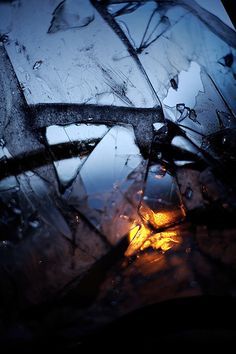 an image of some ice on the ground with water droplets and light coming from it