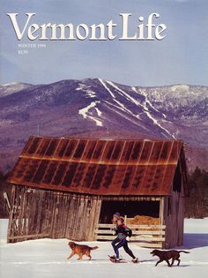 the cover of vermont life magazine features a woman on skis and two dogs in front of a barn