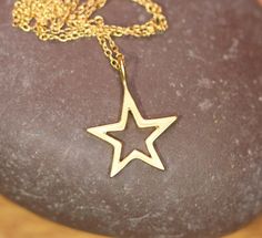 Gold star necklace, celestial necklace, silver star outline pendant, twinkle twinkle little star, layering necklace, little sister gift idea A perfectly cute gold vermeil star hanging from a 16 inch 14k gold vermeil chain. Please feel free to select a different length chain if you prefer. This star necklace is also available in sterling silver :) Star Measurement: 15mm Need an energy boost or a little healing? Or just a pop of color? https://www.etsy.com/listing/165088081/add-a-gemstone-power-bo Gold Star Charm Necklace Handmade, Handmade Gold Star Charm Necklaces, Handmade Gold Star Charm Necklace, Handmade Gold Charm Necklaces With Star Shape, Cute Gold Jewelry With Star Charm, Cute Gold Star Jewelry, Gold Jewelry With Star Print For Gift, Silver Star Necklace, Star Outline