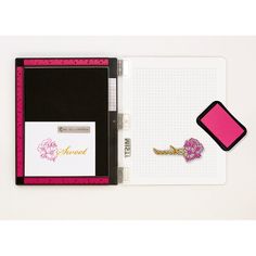 an open notebook with pink and black accents