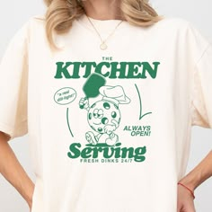 Are you a pickleball aficionado with a sense of humor as sharp as your serve? Look no further! Our "Serving Fresh Dinks" t-shirt is designed for players who live and breathe pickleball, offering not just comfort but a hefty dose of humor on the court. This isn't just any shirt; it's your new go-to gear for making a statement without saying a word. Features: Retro Vibes: With a design that throws it back to the golden days of sports fashion, this retro shirt is perfect for both on and off the cou Pickleball Graphic Tee, Pickleball Shirt Design, Green Graphic Print Top For Pickleball, Pickle Ball Shirt, Retro T Shirt Designs, Retro Tshirt Design, Pickleball Shirts, Pickleball Design, Funny Pickleball Shirts