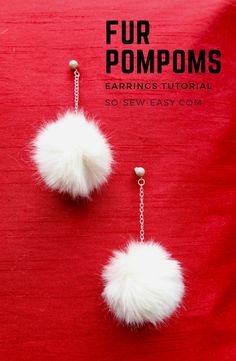 two white pom poms hanging from chains on a red surface with text overlay that says fur pompoms