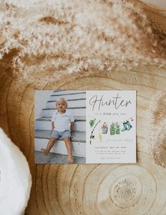 a little boy sitting on top of a tree stump next to a card that says, halloween