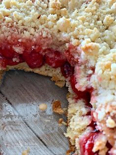 a close up of a cake with crumbs on it's crust and some fruit in the middle