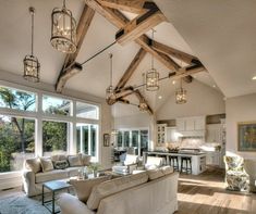 a living room filled with furniture and lots of windows