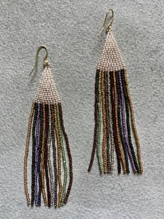 Marni Loesel makes delicate beaded earrings that bring out our inner hippie. The fluid movement of these flowing designs is simply beguiling. Be sure to wear some flowers in your hair... Multi-colored beads on gold wires, 3 1/2 inches long Multicolor Dangle Beaded Earrings With Gold Beads, Celebration Dangle Beaded Earrings, Celebration Dangle Beaded Earrings With Ear Wire, Elegant Earrings With Tiny Beads For Festivals, Elegant Festival Earrings With Tiny Beads, Bohemian Beaded Chain Earrings For Party, Elegant Multicolor Beaded Earrings With Tiny Beads, Bohemian Party Earrings With Tiny Beads, Elegant Gold Beaded Earrings For Festival