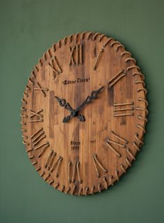 a wooden clock with roman numerals on it