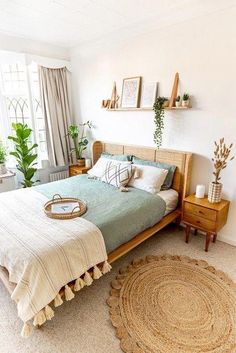 a bed room with a neatly made bed and a rug on the floor next to it