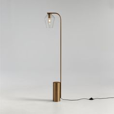 a lamp that is on top of a white surface with a wire attached to it