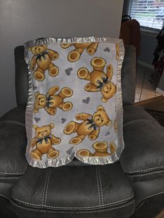 a teddy bear blanket is sitting on a chair