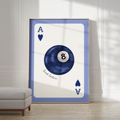 a blue and white pool ball with the number eight on it in front of a chair