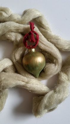 an ornament is sitting on top of some yarn