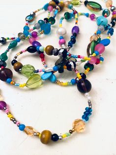 "This is a fun, super colorful, boho style beaded necklace. I made it with an assortment of stone, glass, plastic and metal bead, seed beads, pearls and more! Wear it long or wrap it! Length: 54\"; has no clasp.    Thank you so very much for visiting my shop!!  Click here for more: http://www.etsy.com/shop/jHenSunshine  New to my shop? See my policies section for any additional questions." Hippie Style Green Beaded Necklace For Festivals, Bohemian Multi-strand Small Beads, Turquoise Beaded Long Necklace For Festivals, Long Turquoise Beaded Necklace For Festivals, Summer Multi-strand Colorful Beaded Necklaces, Spiritual Multi-strand Beaded Long Necklace, Bohemian Czech Glass Tiny Beads, Long Metal Beaded Necklaces, Hippie Style Green Beaded Necklaces With Round Beads