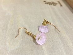 These earrings feature pink Czech Crystal lotus seed pods. The ear wires are brass filled 14k gold plated. Suitable for any occasion! Perfect as a gift for your loved one, mother, and friends!  Size: 1cm x 3 cm  *Please note that there might be slight variation in the colour and size (1-2mm) of the lotus pod* ---------------------------- 🌟Maintenance  - To prevent tarnishing, place the item in a zipped bag and box when not using. 🌟Follow us on Instagram and tag us to be featured : @katecraftsxx 🌟Please check out more design in our shop: https://www.etsy.com/ca/shop/Katelifestyle  ---------------------------- Please feel free to contact me with any questions!  Thank you for visiting Katelifestyle.  Hope you will come again! Kate xoxo Feminine Earrings With Ear Wire As Gift, Wire Wrapped Rose Gold Earrings For Gift, Feminine Flower Earrings With Ear Wire For Gifts, Pink Wire Wrapped Earrings For Gift, Wire Wrapped Dangle Flower Earrings For Gift, Wire Wrapped Dangle Flower Earrings As Gift, Gift Crystal Flower Earrings With Ear Wire, Pink Gold Earrings With Ear Wire For Gift, Pink Gold Jewelry With Ear Wire For Gifts