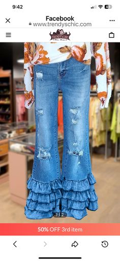 a pair of jeans with ruffles on the bottom are being displayed in a store