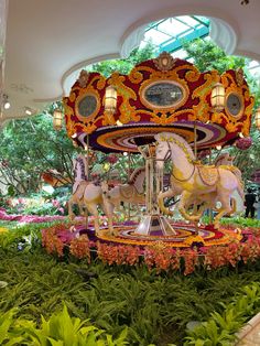 the carousel is decorated with flowers and lights