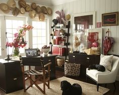 a living room filled with furniture and lots of clutter on top of the table