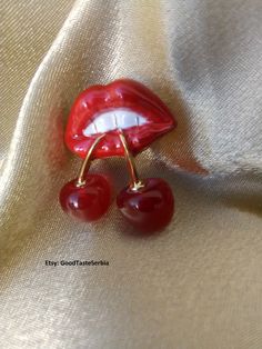 a pair of red lips and two cherries