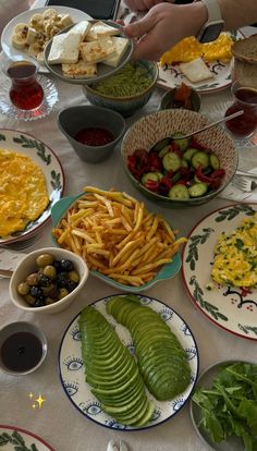 a table topped with plates and bowls filled with food