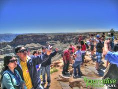 a group of people standing at the edge of a cliff