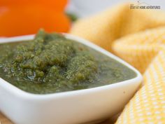 a small white bowl filled with green sauce