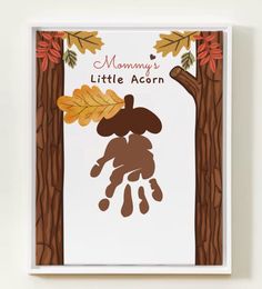 a card with the words mommy's little acorn on it and an image of a hand holding leaves